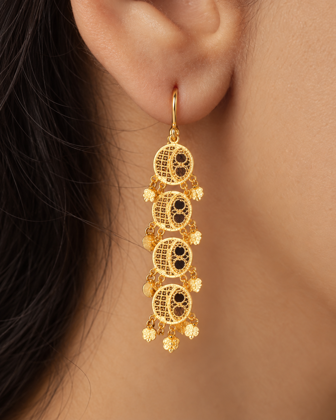 Gold filigree earrings with four cascading discs and flower charms