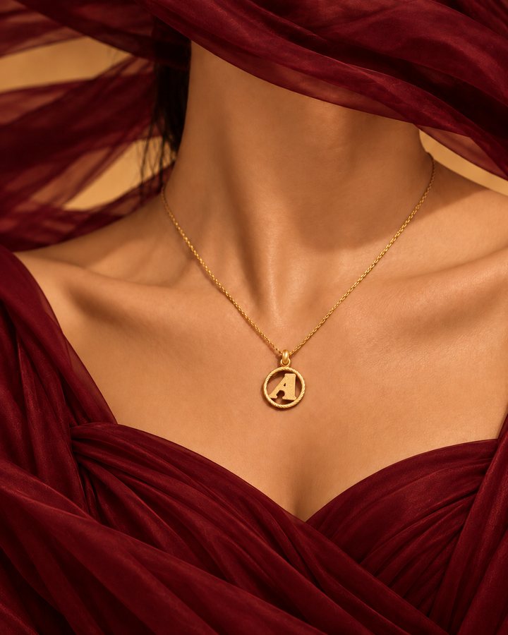 Letter A gold initial necklace worn at the collarbone