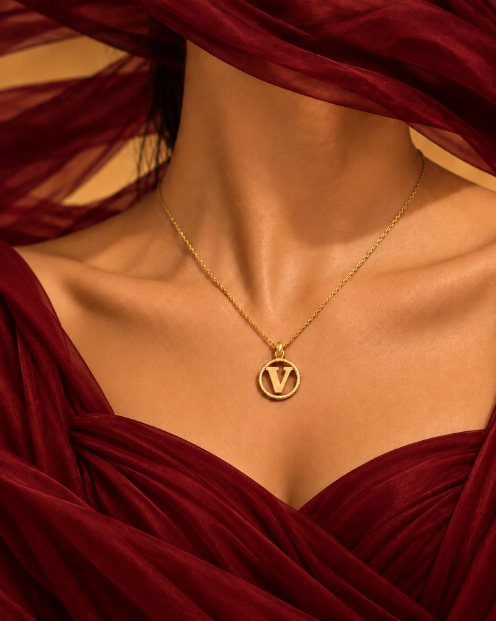 Letter V gold initial necklace worn at the collarbone