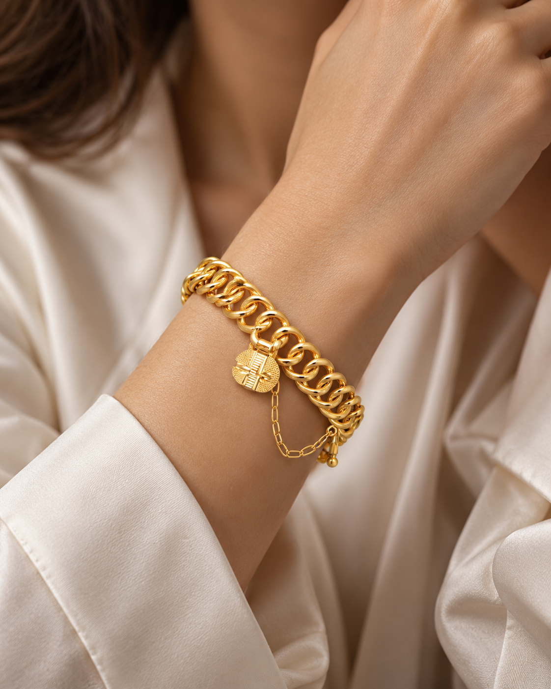 Gold double ring link bracelet with engraved padlock charm and safety chain