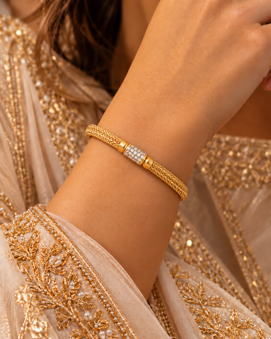 Gold woven mesh bangle with a pavé white-stone barrel centre