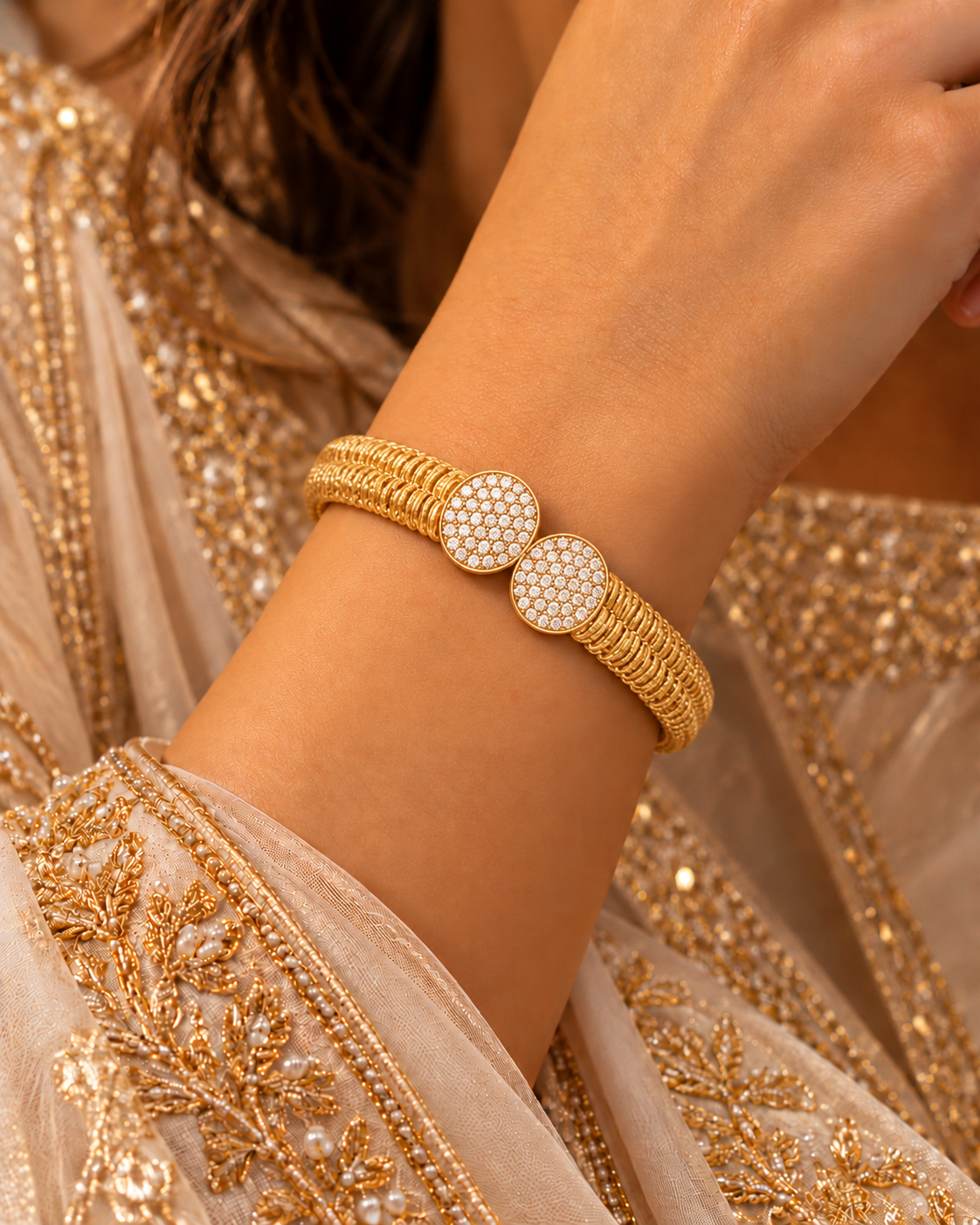 Double-row coiled gold bangle with two round pavé white-stone discs